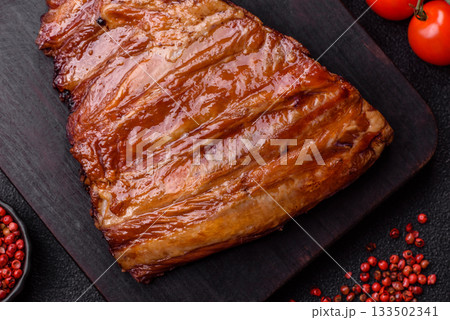 Grilled or barbecued pork or beef ribs with sauce. Cooked or smoked ribs Grilled or barbecued pork or beef ribs with sauce. Cooked or smoked ribs 133502341