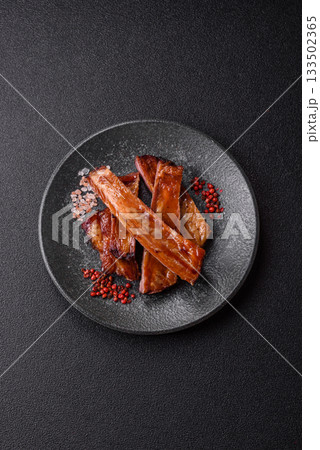 Grilled or barbecued pork or beef ribs with sauce. Cooked or smoked ribs Grilled or barbecued pork or beef ribs with sauce. Cooked or smoked ribs 133502365