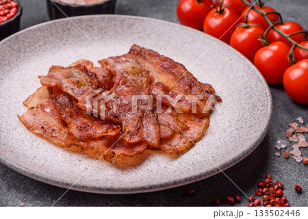 Fried pork bacon slices or strips as a breakfast ingredient. Fried bacon 133502446