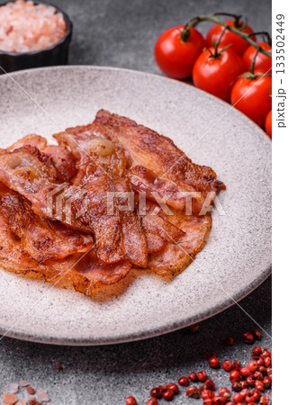Fried pork bacon slices or strips as a breakfast ingredient. Fried bacon 133502449