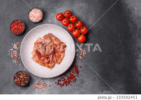 Fried pork bacon slices or strips as a breakfast ingredient. Fried bacon 133502451