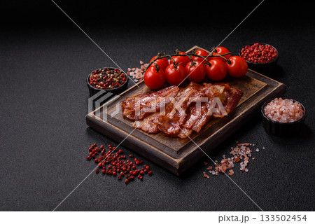 Fried pork bacon slices or strips as a breakfast ingredient. Fried bacon Fried pork bacon slices or strips as a breakfast ingredient. Fried bacon 133502454