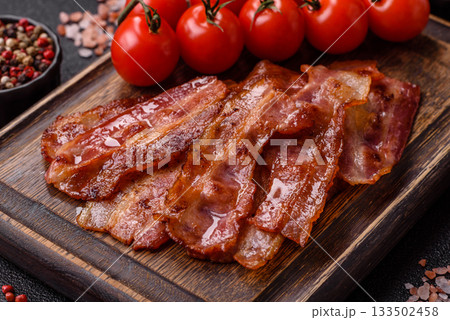 Fried pork bacon slices or strips as a breakfast ingredient. Fried bacon Fried pork bacon slices or strips as a breakfast ingredient. Fried bacon 133502458
