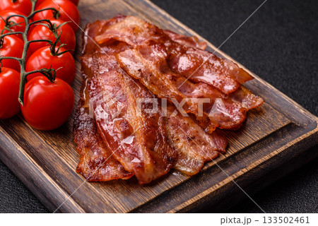 Fried pork bacon slices or strips as a breakfast ingredient. Fried bacon Fried pork bacon slices or strips as a breakfast ingredient. Fried bacon 133502461