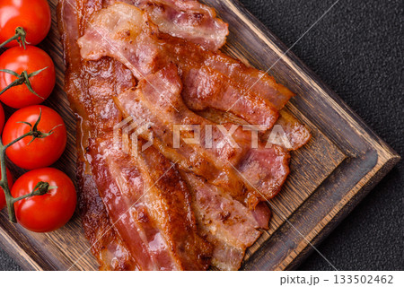 Fried pork bacon slices or strips as a breakfast ingredient. Fried bacon Fried pork bacon slices or strips as a breakfast ingredient. Fried bacon 133502462