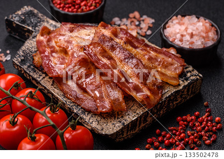 Fried pork bacon slices or strips as a breakfast ingredient. Fried bacon Fried pork bacon slices or strips as a breakfast ingredient. Fried bacon 133502478