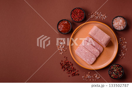 Spiced ham slices, canned meat for lunch sandwiches. Spiced ham as a food background Spiced ham slices, canned meat for lunch sandwiches. Spiced ham as a food background 133502787