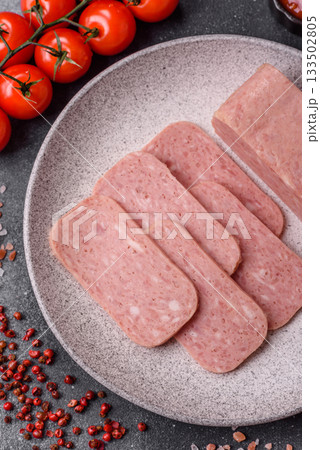 Spiced ham slices, canned meat for lunch sandwiches. Spiced ham as a food background Spiced ham slices, canned meat for lunch sandwiches. Spiced ham as a food background 133502805
