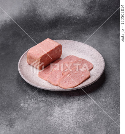 Spiced ham slices, canned meat for lunch sandwiches. Spiced ham as a food background Spiced ham slices, canned meat for lunch sandwiches. Spiced ham as a food background 133502814