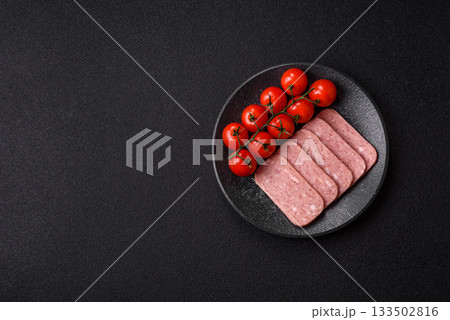Spiced ham slices, canned meat for lunch sandwiches. Spiced ham as a food background 133502816