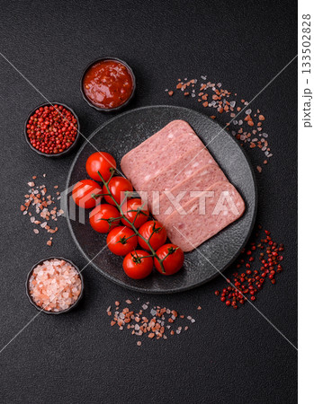 Spiced ham slices, canned meat for lunch sandwiches. Spiced ham as a food background 133502828