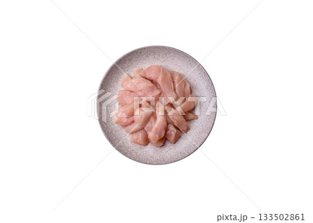 Strips of raw chicken or turkey fillet, skinless and boneless poultry breast. Chicken fillet strips Strips of raw chicken or turkey fillet, skinless and boneless poultry breast. Chicken fillet strips 133502861