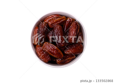 Dried dates in a ceramic plate, arabic food for the ramadan table. Dried dates as a food backgrounds 133502868
