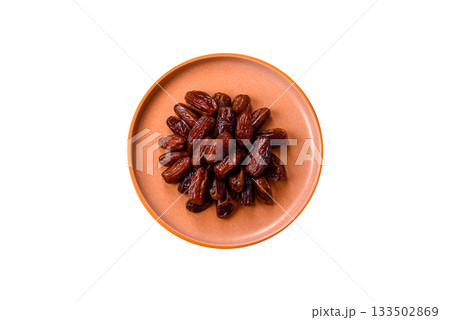 Dried dates in a ceramic plate, arabic food for the ramadan table. Dried dates as a food backgrounds 133502869