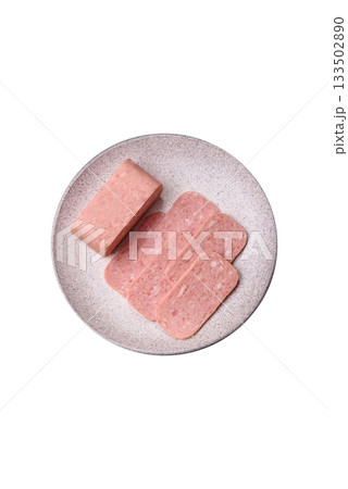 Spiced ham slices, canned meat for lunch sandwiches. Spiced ham as a food background 133502890
