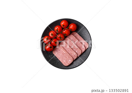 Spiced ham slices, canned meat for lunch sandwiches. Spiced ham as a food background Spiced ham slices, canned meat for lunch sandwiches. Spiced ham as a food background 133502891