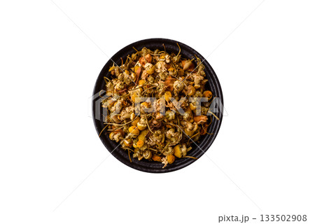 Dried chamomile flowers, herbal tea in a bowl for a hot morning drink. Dried chamomile Dried chamomile flowers, herbal tea in a bowl for a hot morning drink. Dried chamomile 133502908