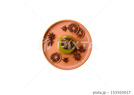 Pistachio cake or tart topped with green mousse with nuts and fruit filling. Pistachio pie 133503017