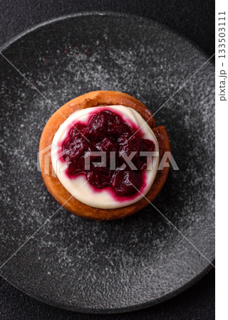 Cinnamon roll, a sweet bun with citrus, cherries, and chocolate, a Danish dessert with cream Cinnamon roll, a sweet bun with citrus, cherries, and chocolate, a Danish dessert with cream 133503111