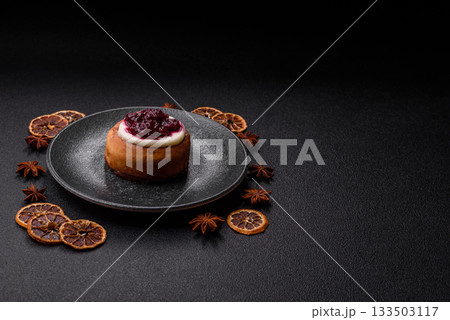 Cinnamon roll, a sweet bun with citrus, cherries, and chocolate, a Danish dessert with cream 133503117