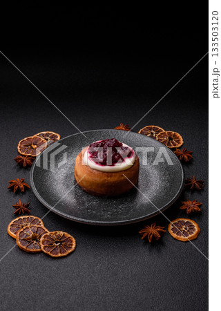 Cinnamon roll, a sweet bun with citrus, cherries, and chocolate, a Danish dessert with cream Cinnamon roll, a sweet bun with citrus, cherries, and chocolate, a Danish dessert with cream 133503120