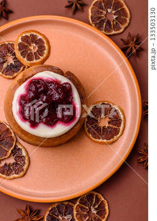 Cinnamon roll, a sweet bun with citrus, cherries, and chocolate, a Danish dessert with cream Cinnamon roll, a sweet bun with citrus, cherries, and chocolate, a Danish dessert with cream 133503130