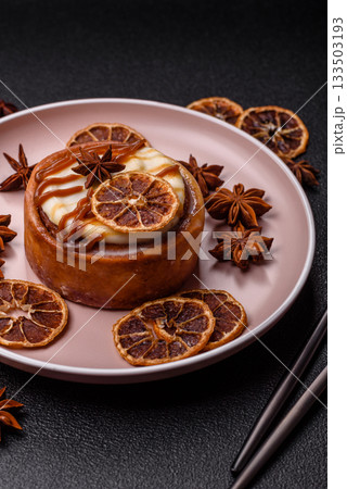 Cinnamon roll, a sweet bun with citrus, cherries, and chocolate, a Danish dessert with cream 133503193