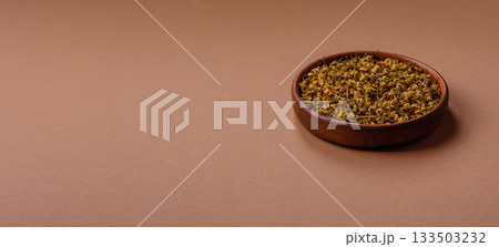 Dried chamomile flowers, herbal tea in a bowl for a hot morning drink. Dried chamomile 133503232