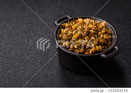 Dried chamomile flowers, herbal tea in a bowl for a hot morning drink. Dried chamomile 133503254