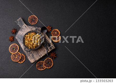 Dried chamomile flowers, herbal tea in a bowl for a hot morning drink. Dried chamomile Dried chamomile flowers, herbal tea in a bowl for a hot morning drink. Dried chamomile 133503263