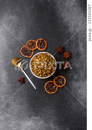 Dried chamomile flowers, herbal tea in a bowl for a hot morning drink. Dried chamomile Dried chamomile flowers, herbal tea in a bowl for a hot morning drink. Dried chamomile 133503267