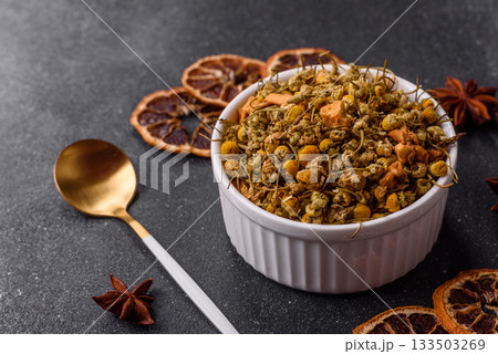 Dried chamomile flowers, herbal tea in a bowl for a hot morning drink. Dried chamomile Dried chamomile flowers, herbal tea in a bowl for a hot morning drink. Dried chamomile 133503269