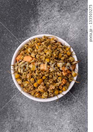 Dried chamomile flowers, herbal tea in a bowl for a hot morning drink. Dried chamomile 133503275