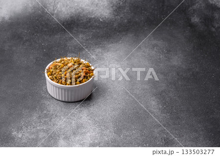 Dried chamomile flowers, herbal tea in a bowl for a hot morning drink. Dried chamomile Dried chamomile flowers, herbal tea in a bowl for a hot morning drink. Dried chamomile 133503277