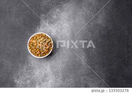 Dried chamomile flowers, herbal tea in a bowl for a hot morning drink. Dried chamomile Dried chamomile flowers, herbal tea in a bowl for a hot morning drink. Dried chamomile 133503278