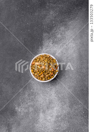 Dried chamomile flowers, herbal tea in a bowl for a hot morning drink. Dried chamomile Dried chamomile flowers, herbal tea in a bowl for a hot morning drink. Dried chamomile 133503279