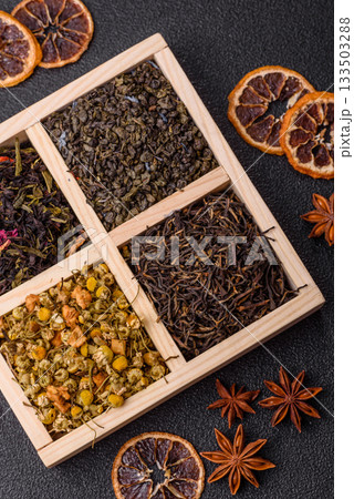 A wooden box with several types of dried tea, green, black, fruit, and chamomile. Dry tea in the box A wooden box with several types of dried tea, green, black, fruit, and chamomile. Dry tea in the box 133503288