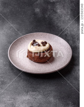 Cinnamon roll, a sweet bun with citrus, cherries, and chocolate, a Danish dessert with cream 133503340