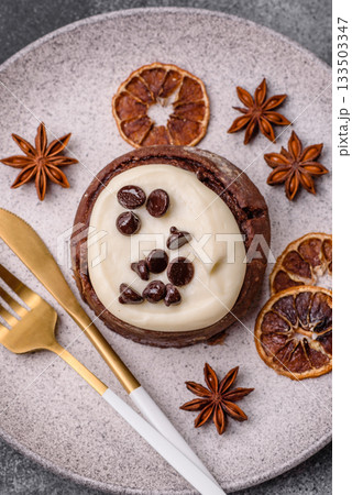 Cinnamon roll, a sweet bun with citrus, cherries, and chocolate, a Danish dessert with cream 133503347