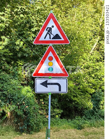 Road works: temporary traffic lights and detour sign 133503421