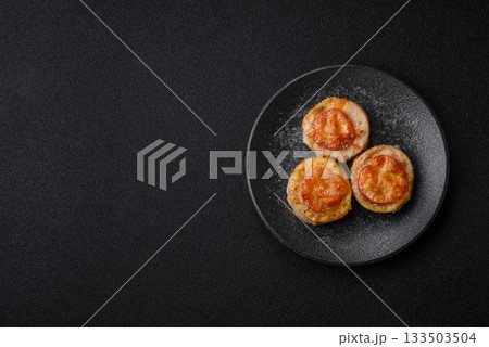 Round fish or chicken cutlets baked with tomato and cheese. Fish cutlets 133503504
