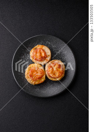 Round fish or chicken cutlets baked with tomato and cheese. Fish cutlets 133503505