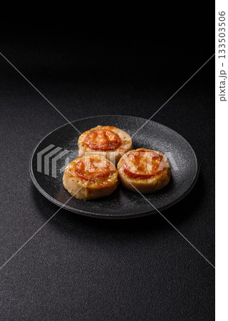 Round fish or chicken cutlets baked with tomato and cheese. Fish cutlets 133503506