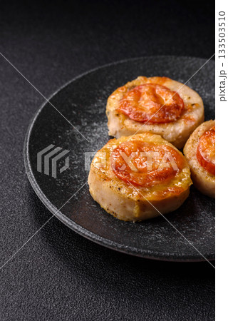 Round fish or chicken cutlets baked with tomato and cheese. Fish cutlets 133503510