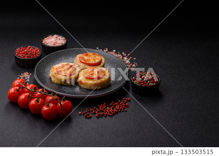 Round fish or chicken cutlets baked with tomato and cheese. Fish cutlets 133503515