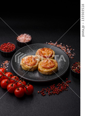 Round fish or chicken cutlets baked with tomato and cheese. Fish cutlets 133503518