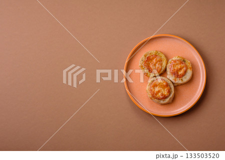 Round fish or chicken cutlets baked with tomato and cheese. Fish cutlets 133503520