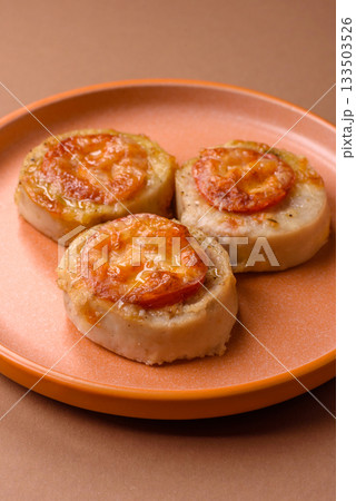 Round fish or chicken cutlets baked with tomato and cheese. Fish cutlets Round fish or chicken cutlets baked with tomato and cheese. Fish cutlets 133503526