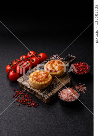Round fish or chicken cutlets baked with tomato and cheese. Fish cutlets Round fish or chicken cutlets baked with tomato and cheese. Fish cutlets 133503538