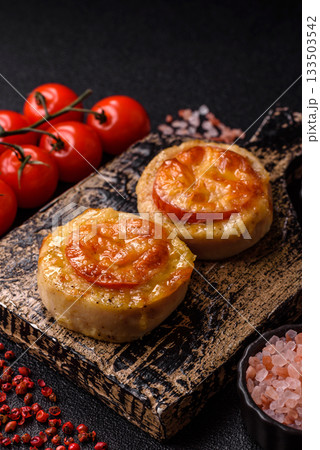 Round fish or chicken cutlets baked with tomato and cheese. Fish cutlets 133503542